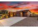 Charming single-Gathering home with desert landscaping and three car garage at sunset at 30804 N 120Th Ave, Peoria, AZ 85383