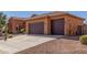 Spacious three-car garage with concrete driveway and desert landscaping at 30804 N 120Th Ave, Peoria, AZ 85383