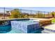 Inviting spa area of the pool is clad in blue tile, and is elevated with a rock waterfall feature at 30804 N 120Th Ave, Peoria, AZ 85383