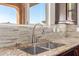 Kitchen sink area featuring granite countertops, tile backsplash, and stainless steel faucet at 30804 N 120Th Ave, Peoria, AZ 85383