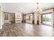 Bright living room with a stone fireplace, built-in shelves, and a view of the pool at 30804 N 120Th Ave, Peoria, AZ 85383