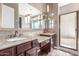 Luxurious main bathroom with double sinks, granite countertops, and walk-in shower at 30804 N 120Th Ave, Peoria, AZ 85383