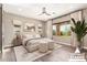 Staged main bedroom with neutral tones, ceiling fan, and natural light at 30804 N 120Th Ave, Peoria, AZ 85383