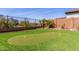 A custom putting green for the golf enthusiast, and desert landscaping adds to the outdoor charm at 30804 N 120Th Ave, Peoria, AZ 85383