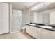 Bright bathroom with double sink vanity, glass shower, and tile flooring at 3115 W Molly Ln, Phoenix, AZ 85083