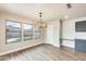 Cozy dining area with backyard views and a modern chandelier at 3115 W Molly Ln, Phoenix, AZ 85083