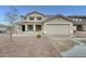 Two-story home with a desert landscape, tile roof, covered porch and a two car garage at 3115 W Molly Ln, Phoenix, AZ 85083