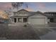 Two-story home with a desert landscape, tile roof, covered porch and a two car garage at 3115 W Molly Ln, Phoenix, AZ 85083