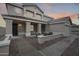 Inviting two-story home with a covered porch, neutral colors and a beautiful tile roof at dusk at 3115 W Molly Ln, Phoenix, AZ 85083