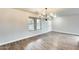 Bright living room with wood flooring, neutral paint, large window, and a modern chandelier at 3115 W Molly Ln, Phoenix, AZ 85083