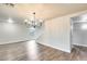 Bright living room with modern chandelier, wood floors, and staircase at 3115 W Molly Ln, Phoenix, AZ 85083