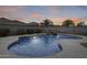 Backyard pool with rock waterfall feature, palm trees, and desert landscaping, perfect for outdoor entertaining at 3115 W Molly Ln, Phoenix, AZ 85083