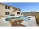 Private backyard pool with rock feature and desert landscaping in a two story single Gathering home at 3115 W Molly Ln, Phoenix, AZ 85083