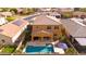 Aerial shot of the backyard showcasing a sparkling blue pool, covered patio, and green turf at 3322 E Lantana Pl, Chandler, AZ 85286