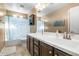 Bright bathroom featuring a large vanity with white countertop and a shower with star-patterned curtain at 3322 E Lantana Pl, Chandler, AZ 85286