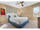 Cozy bedroom featuring a blue bed frame, soft carpet, and bright windows with patterned curtains at 3322 E Lantana Pl, Chandler, AZ 85286