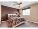 Comfortable bedroom with a patterned duvet cover, soft carpet, and a modern ceiling fan for added comfort at 3322 E Lantana Pl, Chandler, AZ 85286