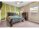 A lovely bedroom features decorative wall accents, a ceiling fan, and a large window for natural light at 3322 E Lantana Pl, Chandler, AZ 85286