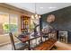 Stylish dining room with a dark accent wall, wooden table, and modern chandelier at 3322 E Lantana Pl, Chandler, AZ 85286