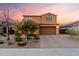 Charming two-story home with well-maintained landscaping, brick driveway, and two-car garage under a colorful sky at 3322 E Lantana Pl, Chandler, AZ 85286