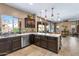 Well-appointed kitchen with dark cabinetry, quartz countertops, and stainless steel appliances at 3322 E Lantana Pl, Chandler, AZ 85286