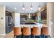 Modern kitchen with stainless steel appliances, a breakfast bar, and tile backsplash at 3322 E Lantana Pl, Chandler, AZ 85286