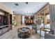 Open-concept living room with tile floors, sliding glass doors, and a glimpse of the kitchen at 3322 E Lantana Pl, Chandler, AZ 85286