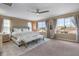 This main bedroom features large windows, a ceiling fan, and stylish decor at 3322 E Lantana Pl, Chandler, AZ 85286