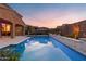 Backyard features a sparkling pool and spa, complete with travertine tile and privacy landscaping at 3322 E Lantana Pl, Chandler, AZ 85286