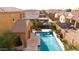 Aerial view of the sparkling pool, covered patio, green landscaping and pavers in the backyard at 3322 E Lantana Pl, Chandler, AZ 85286