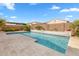 Relax by the sparkling backyard pool with travertine tile decking and desert landscaping at 3322 E Lantana Pl, Chandler, AZ 85286