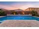 Backyard oasis showcasing the sparkling pool and deck with mature landscaping and block fence at 3322 E Lantana Pl, Chandler, AZ 85286