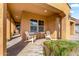 Cozy covered porch featuring comfortable seating, decorative accents, and inviting ambiance at 3322 E Lantana Pl, Chandler, AZ 85286