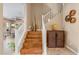 Wood staircase with white railings, decorative vases and a cabinet at the landing at 3322 E Lantana Pl, Chandler, AZ 85286