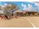 Expansive backyard featuring a fire pit, desert landscaping, and solar panels on the home's roof at 35207 N Central Ave, Phoenix, AZ 85086