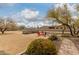 Expansive backyard with a fire pit area surrounded by chairs and a large open space, ideal for outdoor activities at 35207 N Central Ave, Phoenix, AZ 85086