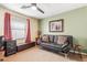 This is a bedroom with two-tone paint, a ceiling fan, and a pull-out couch at 35207 N Central Ave, Phoenix, AZ 85086