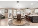 Bright dining area with a chandelier over a round table and tiled floors at 35207 N Central Ave, Phoenix, AZ 85086