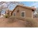 Exterior view of a home showcasing its earthy color scheme and desert landscaping with drought-tolerant plants at 35207 N Central Ave, Phoenix, AZ 85086