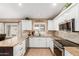 Updated kitchen featuring stainless steel appliances, white cabinets, and granite countertops at 35207 N Central Ave, Phoenix, AZ 85086