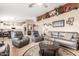 Spacious living room with tile flooring, ceiling fan, and gray couches at 35207 N Central Ave, Phoenix, AZ 85086