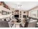 A comfortable living room showcases a fireplace, ceiling fan, and built-in shelving units at 35207 N Central Ave, Phoenix, AZ 85086