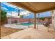 Backyard featuring covered patio with a view of the pool and a relaxing, shaded seating area at 3581 W Mineral Butte Dr, San Tan Valley, AZ 85144