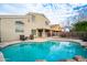 Backyard with a refreshing pool surrounded by a patio and mature trees at 3581 W Mineral Butte Dr, San Tan Valley, AZ 85144