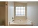 Bright bathroom featuring a soaking tub beneath a window for added natural light at 3581 W Mineral Butte Dr, San Tan Valley, AZ 85144