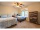 Comfortable bedroom with twin beds, dresser, and natural light from the window at 3581 W Mineral Butte Dr, San Tan Valley, AZ 85144