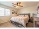 Relaxing bedroom with a ceiling fan, queen bed, and window at 3581 W Mineral Butte Dr, San Tan Valley, AZ 85144