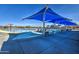 Community pool with shade structures, lounge chairs, and pool furniture in a Gathering-friendly community at 3581 W Mineral Butte Dr, San Tan Valley, AZ 85144