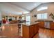 Spacious kitchen with island, stainless steel appliances, open to dining and living area at 3581 W Mineral Butte Dr, San Tan Valley, AZ 85144