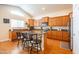 Bright kitchen featuring wood cabinets, granite countertops, and a central island with seating at 3581 W Mineral Butte Dr, San Tan Valley, AZ 85144